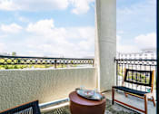 Thumbnail 24 of 24 - a balcony with a table and chairs and a view of the ocean