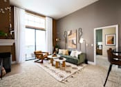 Thumbnail 15 of 24 - a living room with a green couch and two tables