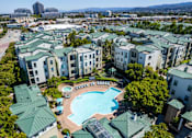 Thumbnail 12 of 24 - an aerial view of a swimming pool in the middle of an apartment complex