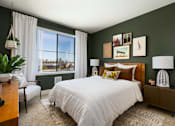 Thumbnail 20 of 24 - a bedroom with green walls and a white bed