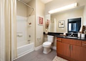 Thumbnail 23 of 24 - a bathroom with a shower toilet and sink and a mirror