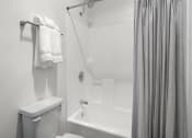 Thumbnail 53 of 53 - a bathroom with a toilet a bathtub and a shower curtain at Enclave, California, 90723