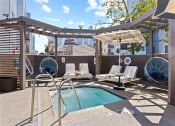 Thumbnail 13 of 53 - a pool with lounge chairs and a pergola at Enclave, Paramount, 90723