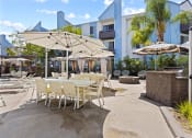Thumbnail 14 of 53 - a patio with tables and chairs and umbrellas at Enclave, Paramount