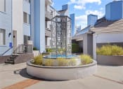 Thumbnail 4 of 53 - a fountain in front of an apartment building at Enclave, Paramount