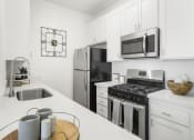 Thumbnail 1 of 53 - a kitchen with a stove top oven next to a sink at Enclave, California