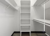 Thumbnail 49 of 53 - a walk in closet with a white shelving unit at Enclave, Paramount California
