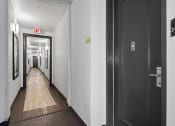 Thumbnail 40 of 53 - a hallway with black doors and white walls  at Enclave, Paramount, CA 90723 