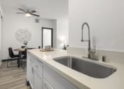 Thumbnail 41 of 53 - a kitchen with a sink and a ceiling fan at Enclave, Paramount, 90723