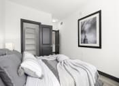 Thumbnail 45 of 53 - a bedroom with a bed and a door to a bathroom at Enclave, Paramount