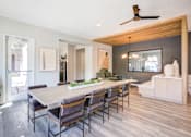 Thumbnail 8 of 38 - a dining room with a wooden table and chairs
