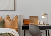 Thumbnail 8 of 36 - a bedroom with a bed and a desk with a clock and a sign on it