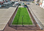 Thumbnail 31 of 36 - a grass field in the middle of a parking lot