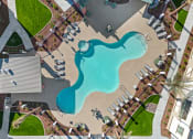 Thumbnail 18 of 36 - an aerial view of a swimming pool at a resort with umbrellas