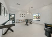Thumbnail 26 of 36 - a game room with two shuffleboards and a foosball table