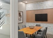 Thumbnail 28 of 36 - a conference room with a wooden table and a television