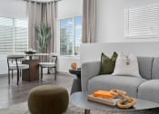 Thumbnail 3 of 36 - a living room with a gray couch and a coffee table