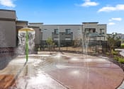 Thumbnail 34 of 36 - a fountain in a courtyard with buildings in the background