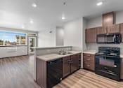 Thumbnail 19 of 50 - A modern kitchen with dark wood floors and brown cabinets.