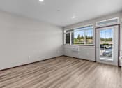 Thumbnail 21 of 50 - Empty room with a window overlooking a tree-filled landscape.
