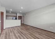 Thumbnail 22 of 50 - A room with wooden flooring and a white countertop.