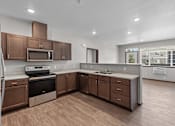 Thumbnail 9 of 50 - A modern kitchen with brown cabinets and stainless steel appliances.