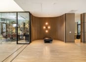 Thumbnail 18 of 32 - a large lobby with a wooden wall and a black chair