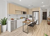 Thumbnail 57 of 58 - A modern kitchen with a dining table and chairs.