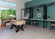 Thumbnail 18 of 24 - a games room with a foosball table and a bar