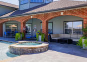 Thumbnail 26 of 33 - a covered patio with a hot tub and a seating area