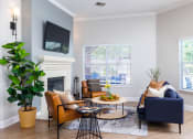 Thumbnail 1 of 33 - a living room with gray walls and a fireplace with a tv above it