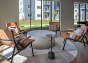 Thumbnail 19 of 27 - Modern living room with a large window and a view of a building at The Arvon, Vancouver