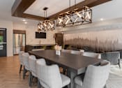 Thumbnail 22 of 35 - A modern dining room with a large table and chairs.