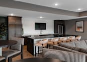 Thumbnail 19 of 35 - A modern kitchen with a dining table and chairs.