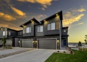 Thumbnail 53 of 54 - a house with two garage doors and a sunset in the background