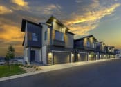 Thumbnail 52 of 54 - a row of houses with garage doors at sunset