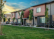 Thumbnail 5 of 26 - A row of modern houses with trees in front.