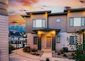Thumbnail 3 of 26 - A modern house with a front yard and a mountain in the background.