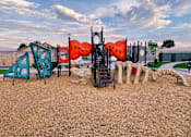 Thumbnail 26 of 26 - A playground with a slide, swings, and other equipment.