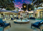 Thumbnail 38 of 52 - A beautifully lit patio with a fountain at the center.