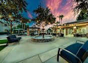 Thumbnail 40 of 52 - A patio with a fire pit and chairs.