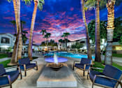 Thumbnail 1 of 52 - A pool surrounded by palm trees and lounge chairs.