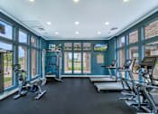 Thumbnail 6 of 52 - A gym with treadmills and exercise bikes.