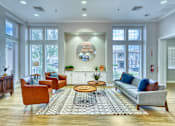 Thumbnail 52 of 52 - A living room with a grey sofa, a coffee table, and a chandelier.