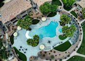 Thumbnail 41 of 52 - A large backyard with a pool and a patio area.