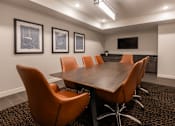Thumbnail 18 of 35 - A conference room with a long table and chairs.
