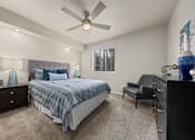 Thumbnail 12 of 21 - a bedroom with a bed and a ceiling fan
