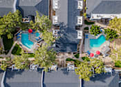 Thumbnail 14 of 21 - a birds eye view of the resort with pools and trees