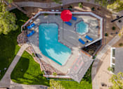 Thumbnail 18 of 21 - arial view of a swimming pool with a red umbrella in the middle