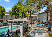 Thumbnail 20 of 21 - our apartments have a swimming pool with a gazebo and lounge chairs